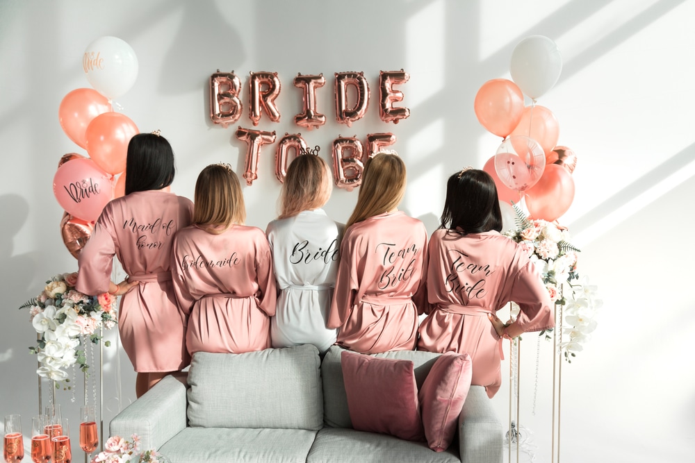 Bride,With,Girlfriends,In,Silk,Robes,At,A,Bachelorette,Party.